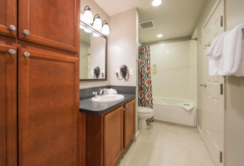 a bathroom with a sink and a toilet and a mirror at Holiday Inn Club Vacations Williamsburg Resort in Williamsburg