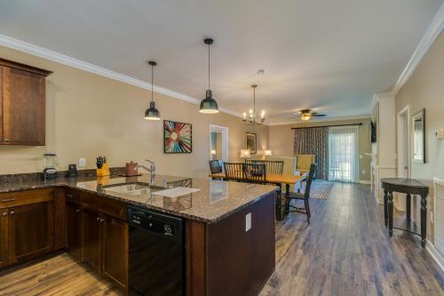a kitchen with a counter and a dining room at Holiday Inn Club Vacations Williamsburg Resort in Williamsburg