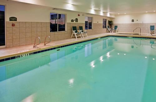 a swimming pool with blue water in a hotel at Holiday Inn Express Hotel & Suites Wichita Airport, an IHG Hotel in Wichita