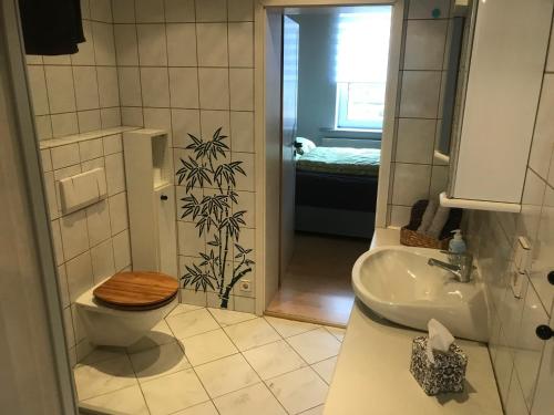 a bathroom with a toilet and a sink at Ferienwohnung Weserbergland Haus Nr 29 Erdgeschoss in Deensen