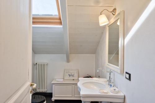 a bathroom with a sink and a mirror at Turin CityView Stylish Loft in Turin