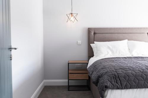 a bedroom with a bed and a nightstand next to a bed sidx sidx sidx at Rooms at the Lower House in Dungannon