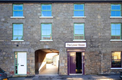 a brick building with a purple door and the lower house at Rooms at the Lower House in Dungannon