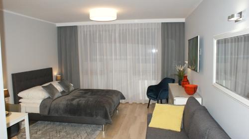 A bed or beds in a room at Apartament Agata