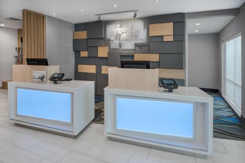 a lobby with two counters with phones on them at Holiday Inn Express & Suites Bryan - College Station by IHG in Bryan
