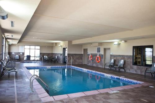 a large swimming pool in a hotel room at Holiday Inn Express and Suites Urbandale Des Moines by IHG in Urbandale