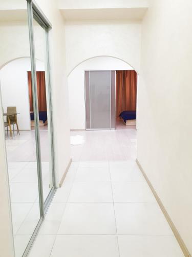 an empty room with glass doors and a white floor at Шикарная VIP квартира 8 мин пешком от м Дарница in Kyiv