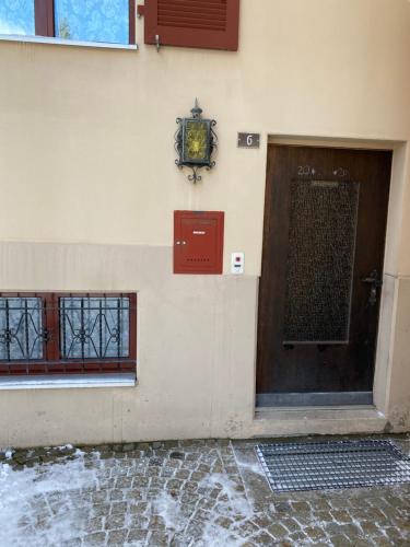 a door on the side of a building with a clock at Privatzimmer / bed & breakfast in Andermatt