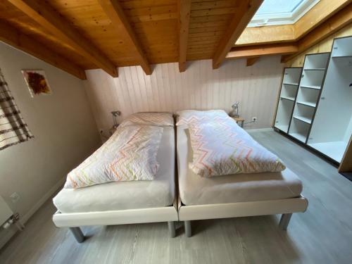 a room with two beds in a tiny house at Privatzimmer / bed & breakfast in Andermatt