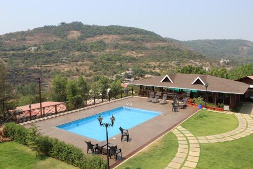 an overhead view of a swimming pool at a resort at Green Velvet Resort-Near Pawna Lake in Lonavala