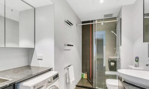 a bathroom with a shower and a toilet and a sink at Luxury 2 bdrm in Watson at Walkerville with Balcony, FREE carpark, near Adelaide CBD in Broadview
