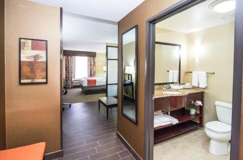 a hotel room with a bathroom with a toilet and a sink at Holiday Inn Express & Suites Elkton - University Area by IHG in Elkton