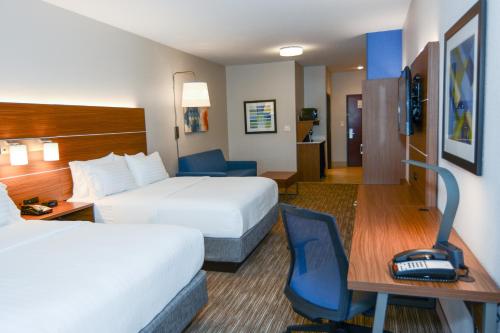 a hotel room with two beds and a desk at Holiday Inn Express Hotel & Suites New Boston by IHG in New Boston