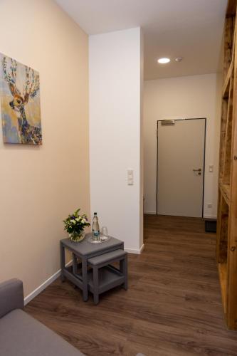 a living room with a table and a door at LOK - Die Pension - Das Restaurant in Tessin