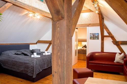 a bedroom with a bed and a chair in a room at Gasthof Mühle in Lübbenau