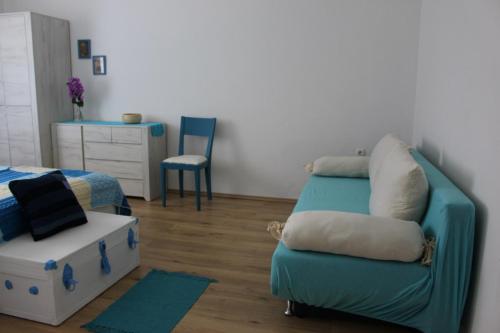 a room with a couch and a bed and a chair at Blue Harbour No. 15 in Veli Iž