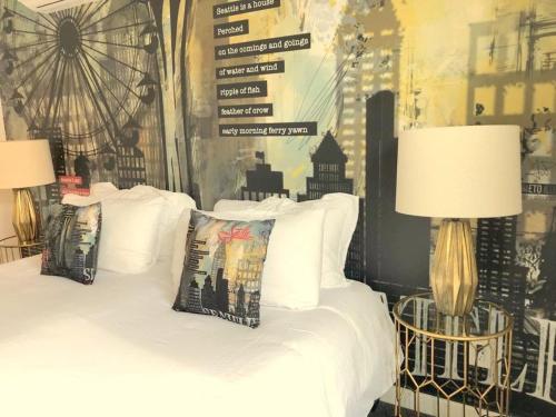 a bedroom with a white bed with two lamps at The ART INN Seattle in Seattle