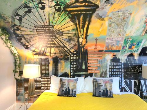 a bedroom with a yellow bed with a painting on the wall at The ART INN Seattle in Seattle
