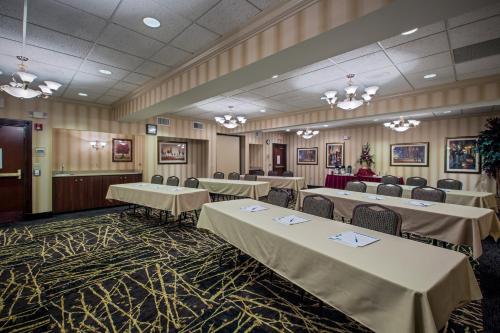 a banquet room with tables and chairs and chandeliers at Holiday Inn Express Hotel & Suites Youngstown North-Warren/Niles by IHG in Warren