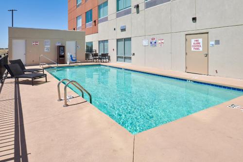 a swimming pool in the middle of a building at Holiday Inn Express & Suites El Paso East-Loop 375 by IHG in El Paso