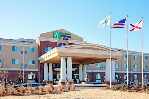 a hotel with two flags in front of a building at Holiday Inn Express Florence Northeast by IHG in Florence