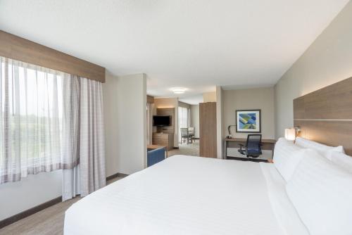 a hotel room with a large bed and a desk at Holiday Inn Express Hotel & Suites Frankfort by IHG in Frankfort