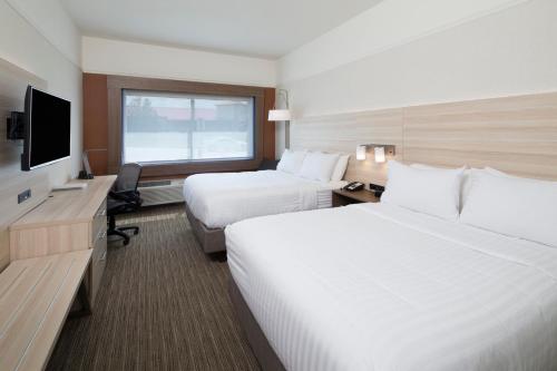a hotel room with two beds and a television at Holiday Inn Express & Suites La Porte by IHG in LaPorte