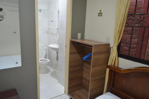a small bathroom with a toilet and a sink at Hotel Balcon Llanero in Cúcuta