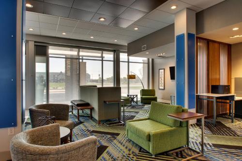 an office lobby with chairs and tables and windows at Holiday Inn Express & Suites Findlay North by IHG in Findlay