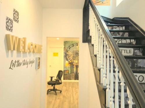 a hallway with a staircase and a chair in a room at The ART INN Seattle in Seattle