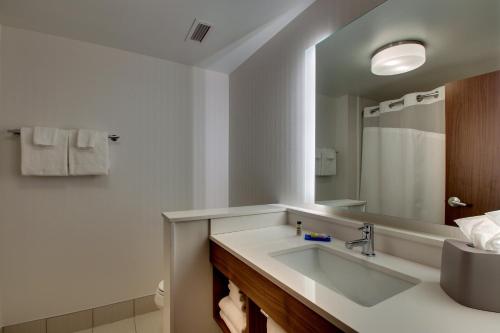 a bathroom with a sink and a mirror at Holiday Inn Express & Suites Findlay North by IHG in Findlay