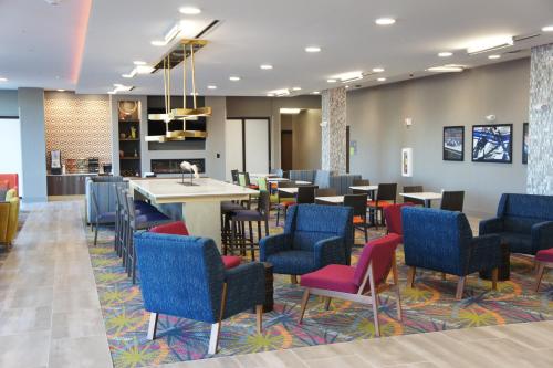 a waiting room with colorful chairs and tables at La Quinta Inn & Suites by Wyndham Braselton in Braselton