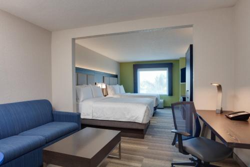 a hotel room with a bed and a couch at Holiday Inn Express Hotel & Suites Fort Lauderdale Airport/Cruise Port, an IHG Hotel in Fort Lauderdale