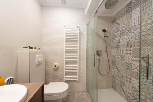 a bathroom with a shower and a toilet and a sink at Apartment Stella in Opatija