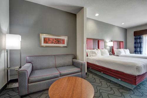 a hotel room with a bed and a couch at Holiday Inn Express and Suites Oklahoma City North by IHG in Oklahoma City