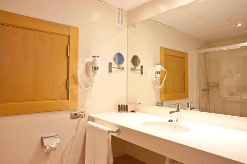 a bathroom with a sink and a mirror at Aparthotel Ponent Mar in Palmanova
