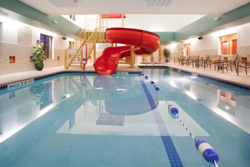 a swimming pool with a slide in the middle at Holiday Inn Express Hotel & Suites Loveland, an IHG Hotel in Loveland