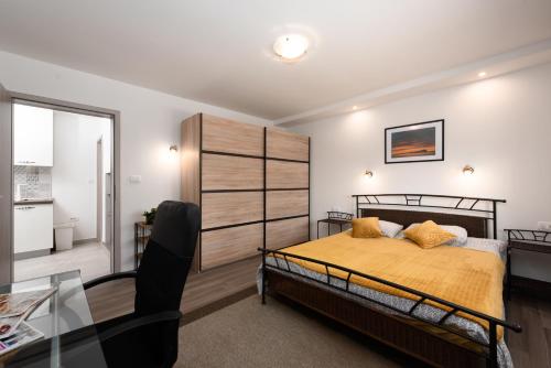 a bedroom with a bed and a glass table at Apartment Stella in Opatija