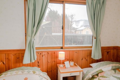 Postel nebo postele na pokoji v ubytování Guest House Chaconne Karuizawa