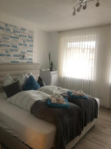 a bedroom with a bed with two towels on it at Pension Ottenheide in Schloß Holte-Stukenbrock