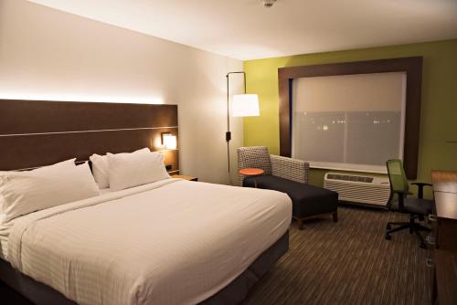 a hotel room with a large bed and a window at Holiday Inn Express & Suites - Rantoul by IHG in Rantoul