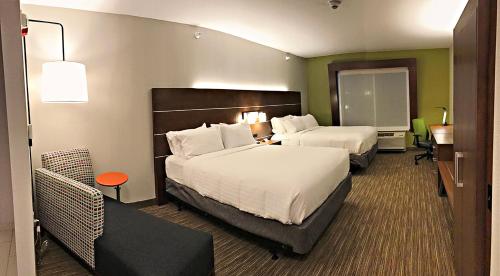 a hotel room with two beds and a desk at Holiday Inn Express & Suites - Rantoul by IHG in Rantoul
