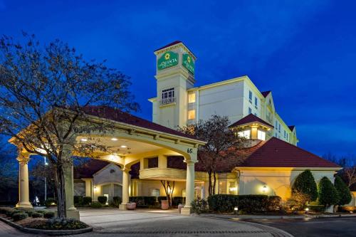 a hotel with a clock tower on top of a building at La Quinta by Wyndham Greenville Haywood in Greenville
