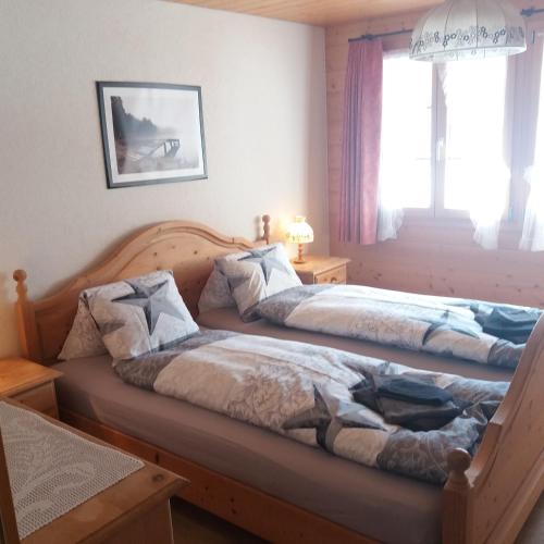 two beds sitting next to each other in a bedroom at Chalet uf em Stutz 2 in Grindelwald