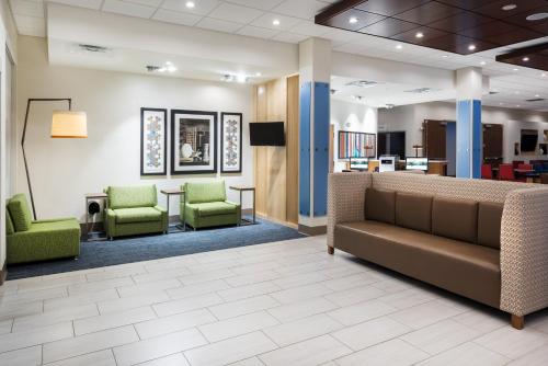 a lobby with a couch and chairs in a hospital at Holiday Inn Express & Suites St. Louis - Chesterfield by IHG in Chesterfield