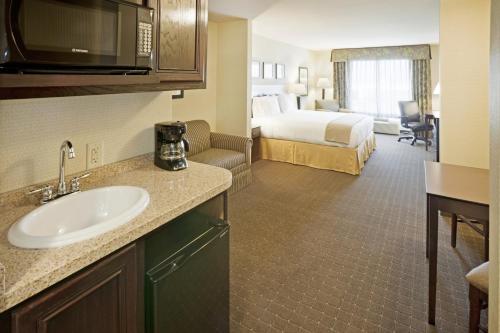 a hotel room with a sink and a bed at Holiday Inn Express Hotel & Suites Eagle Pass, an IHG Hotel in Eagle Pass