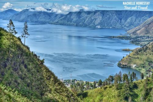 a view of a large lake from a hill at Nachelle Homestay in Berastagi