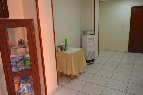 a kitchen with a table and a refrigerator at Hotel Balcon Llanero in Cúcuta