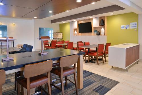 a waiting room at a hospital with tables and chairs at Holiday Inn Express Hotel and Suites Stevens Point by IHG in Stevens Point