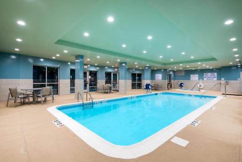 a large swimming pool in a hotel lobby at Holiday Inn Express & Suites Florence I-95 & I-20 Civic Ctr, an IHG Hotel in Florence